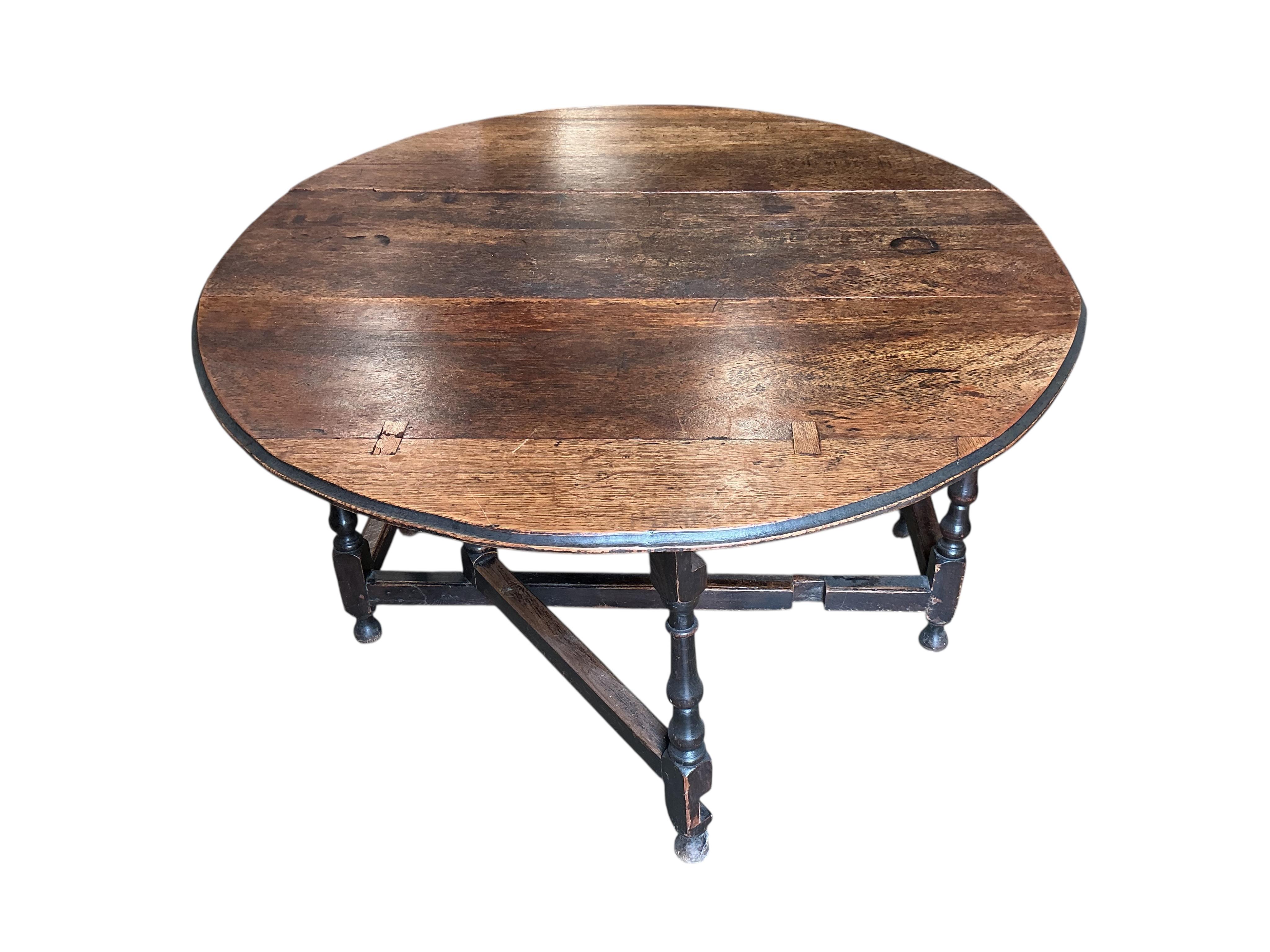 An 18th century oak gateleg table, width 130cm, depth 49cm, height 73cm